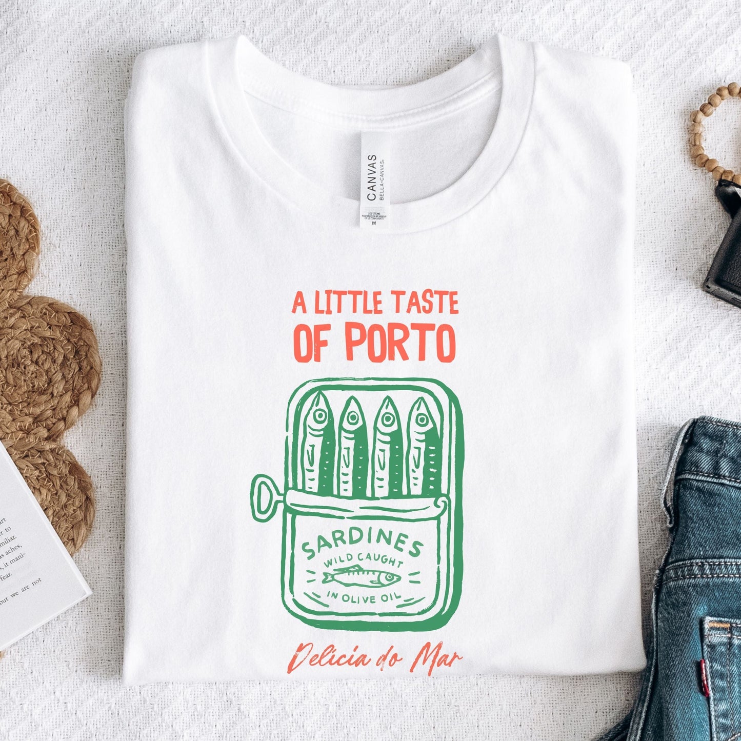 Vintage sardine can design on a t-shirt with “A Little Taste of Porto” text in white