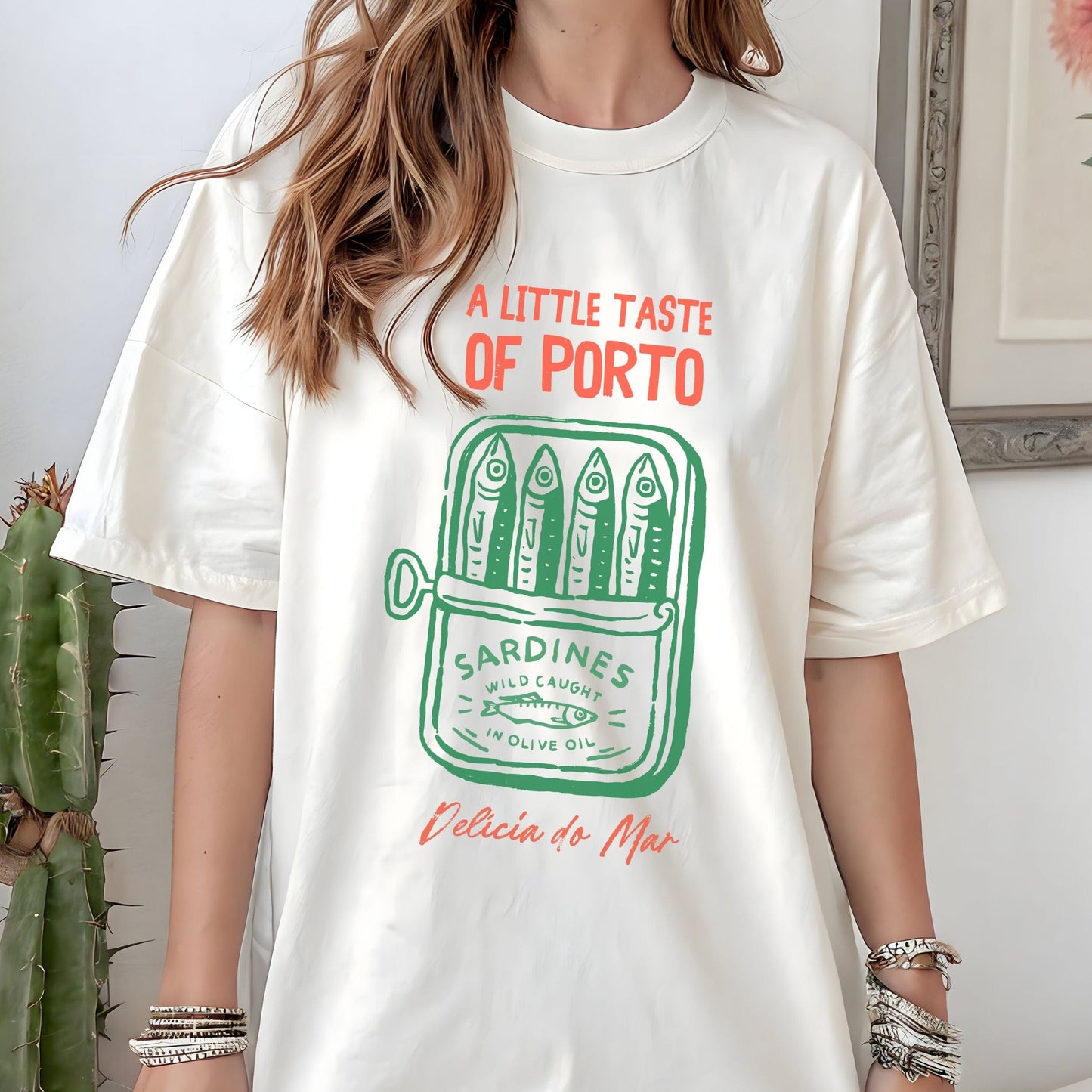 Vintage sardine can design on a t-shirt with “A Little Taste of Porto” text in white