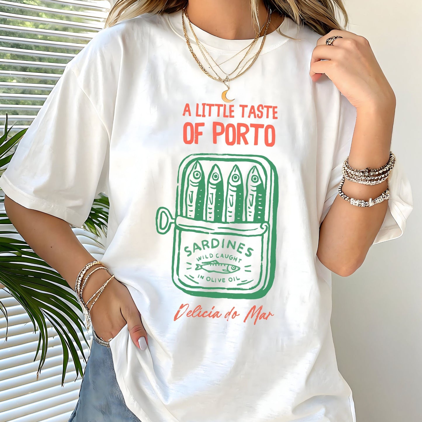 Vintage sardine can design on a t-shirt with “A Little Taste of Porto” text in white