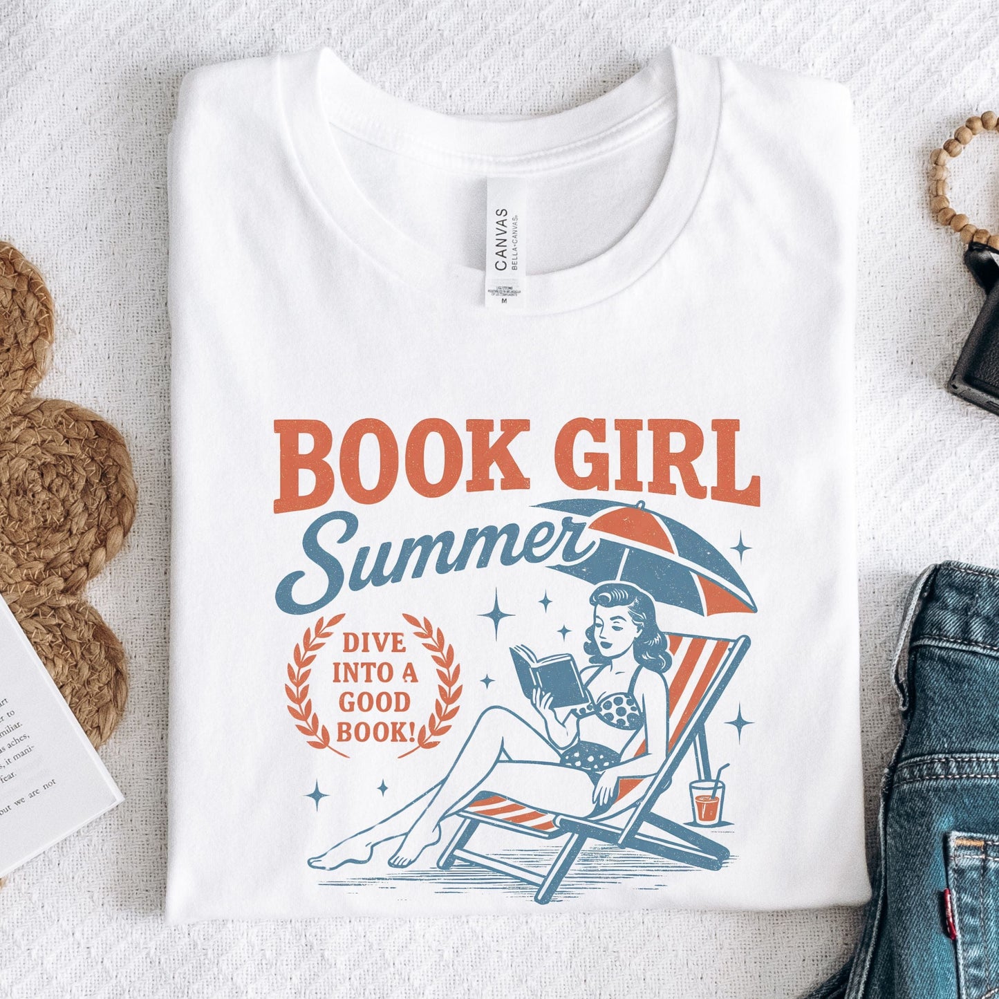 Folded t-shirt with vintage-style swimmer and book illustration in white