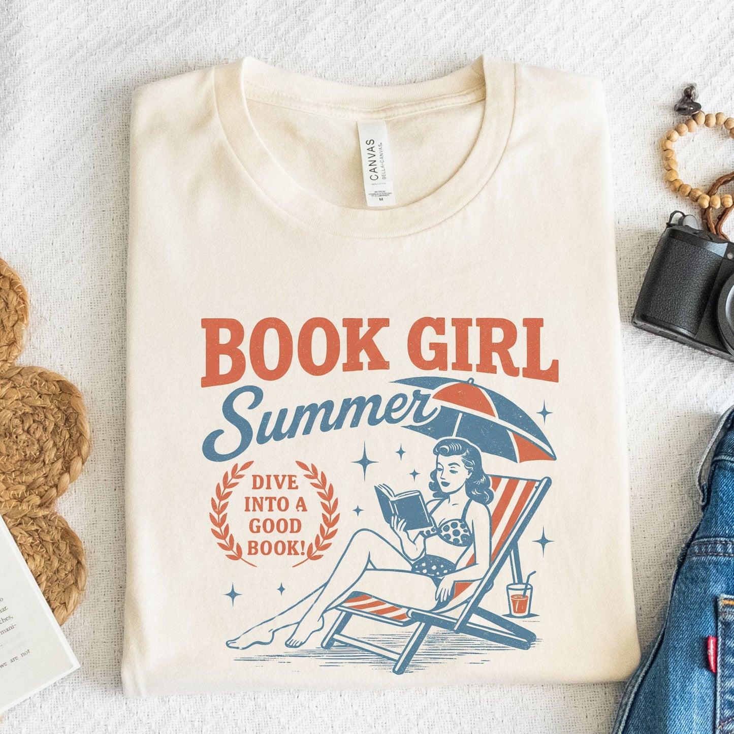 Folded t-shirt with vintage-style swimmer and book illustration in natural
