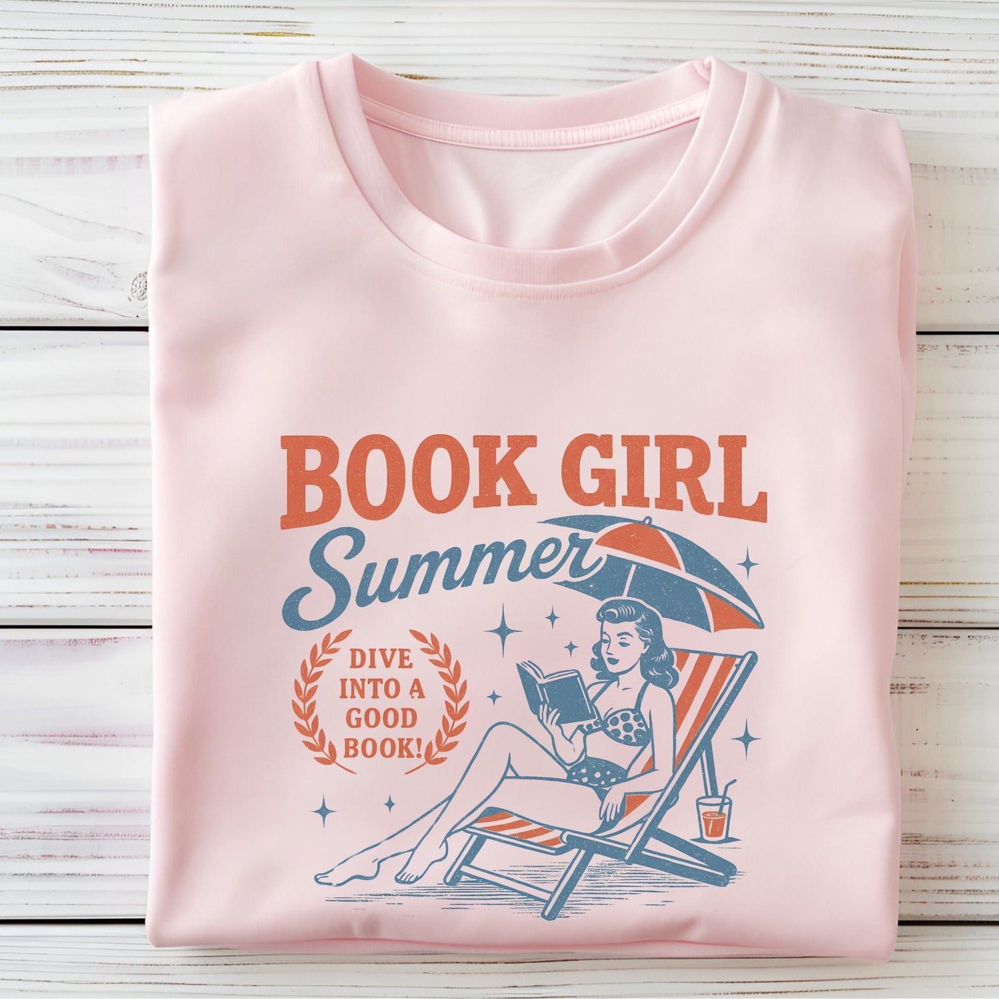 Folded t-shirt with vintage-style swimmer and book illustration in soft pink