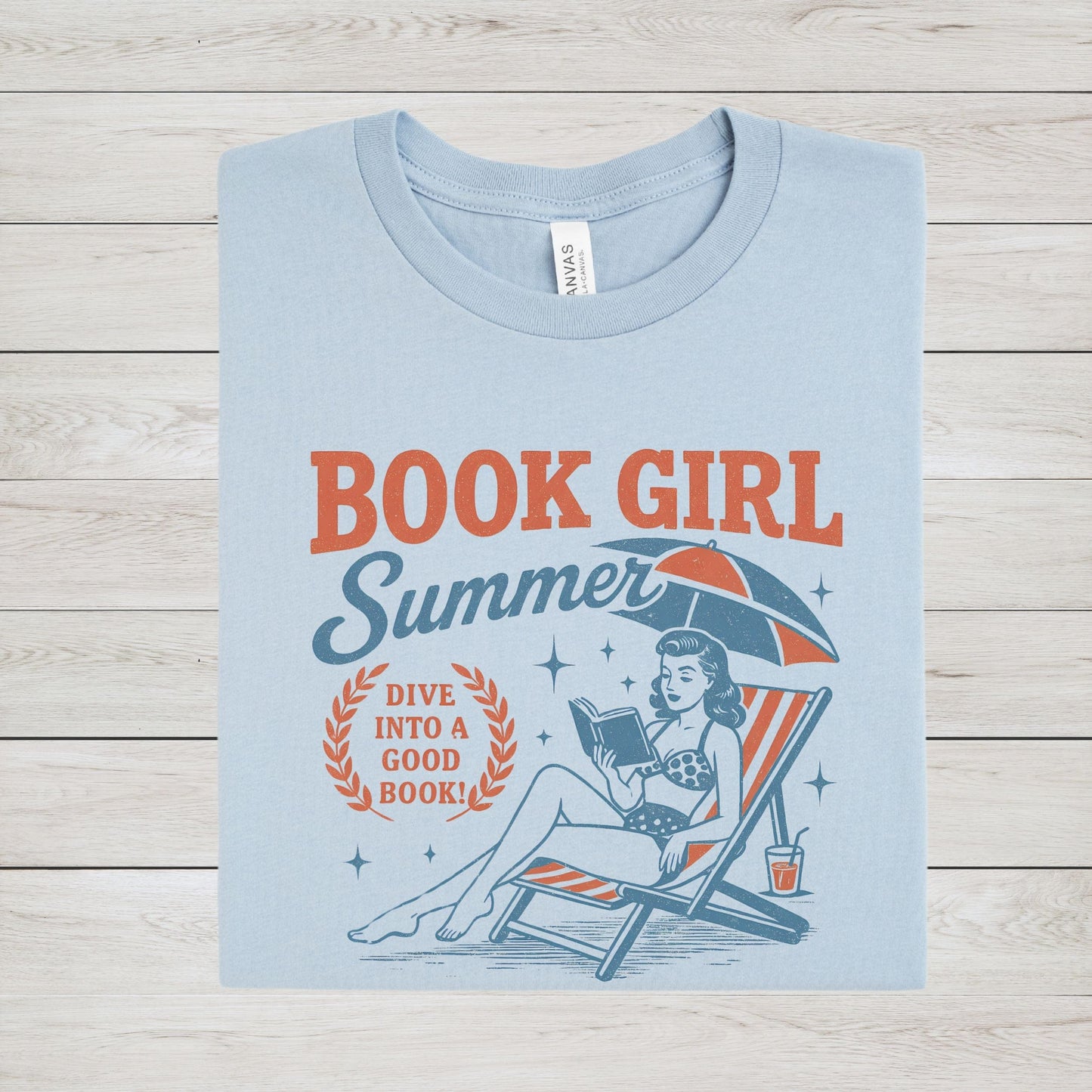 Folded t-shirt with vintage-style swimmer and book illustration in light blue