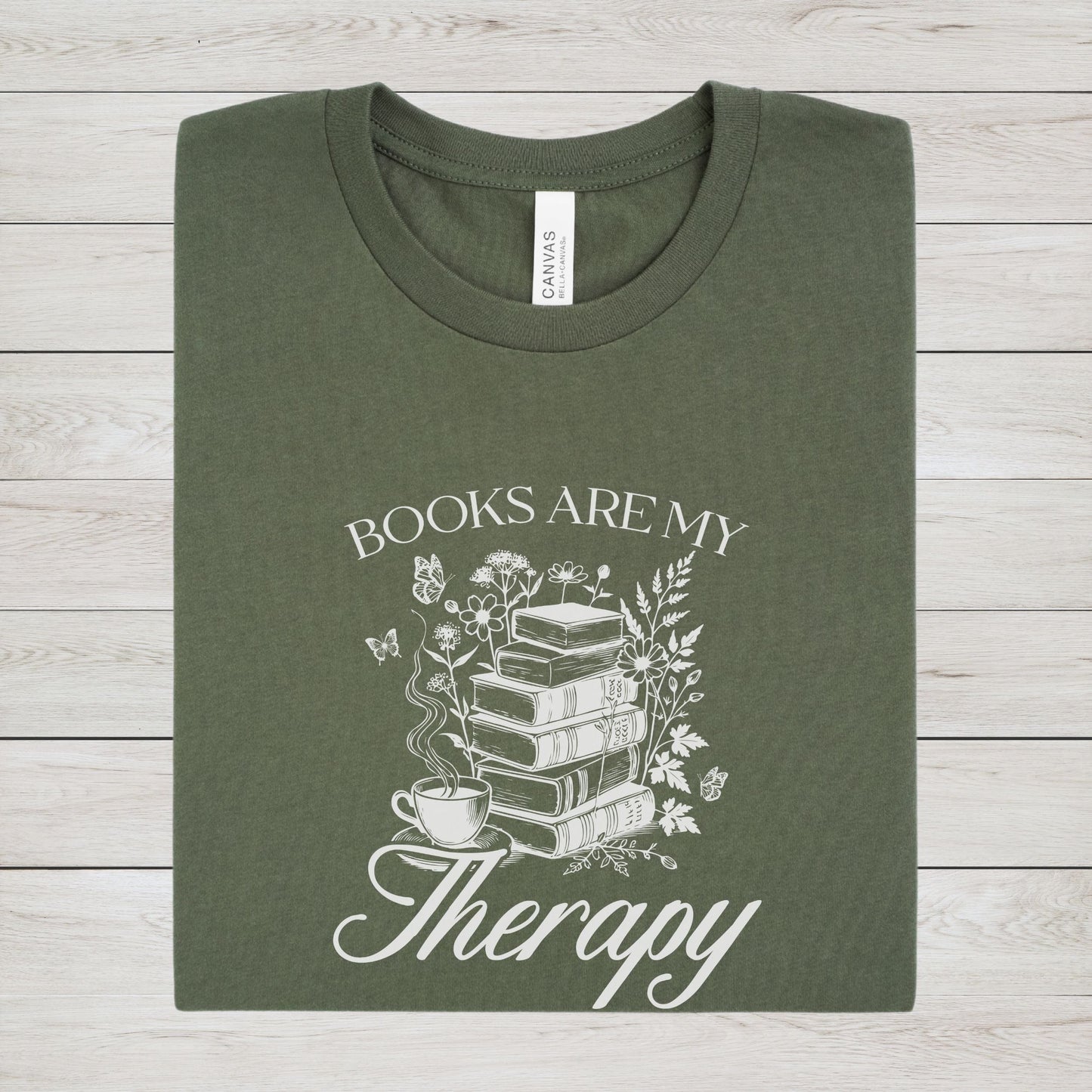 “Books Are My Therapy” t-shirt with vintage floral book stack, butterflies, and a coffee cup — perfect for cozy book lovers.