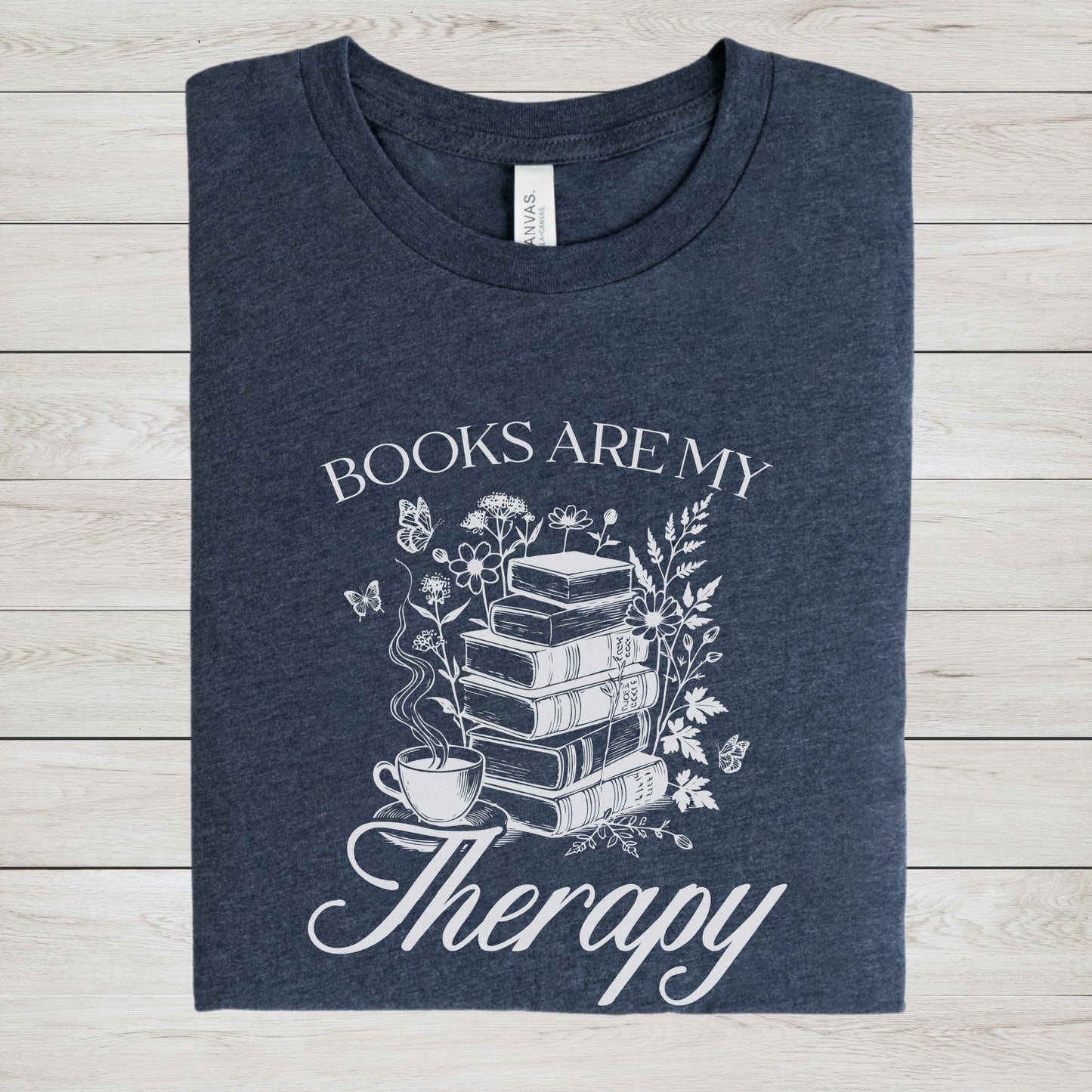 “Books Are My Therapy” t-shirt with vintage floral book stack, butterflies, and a coffee cup — perfect for cozy book lovers.