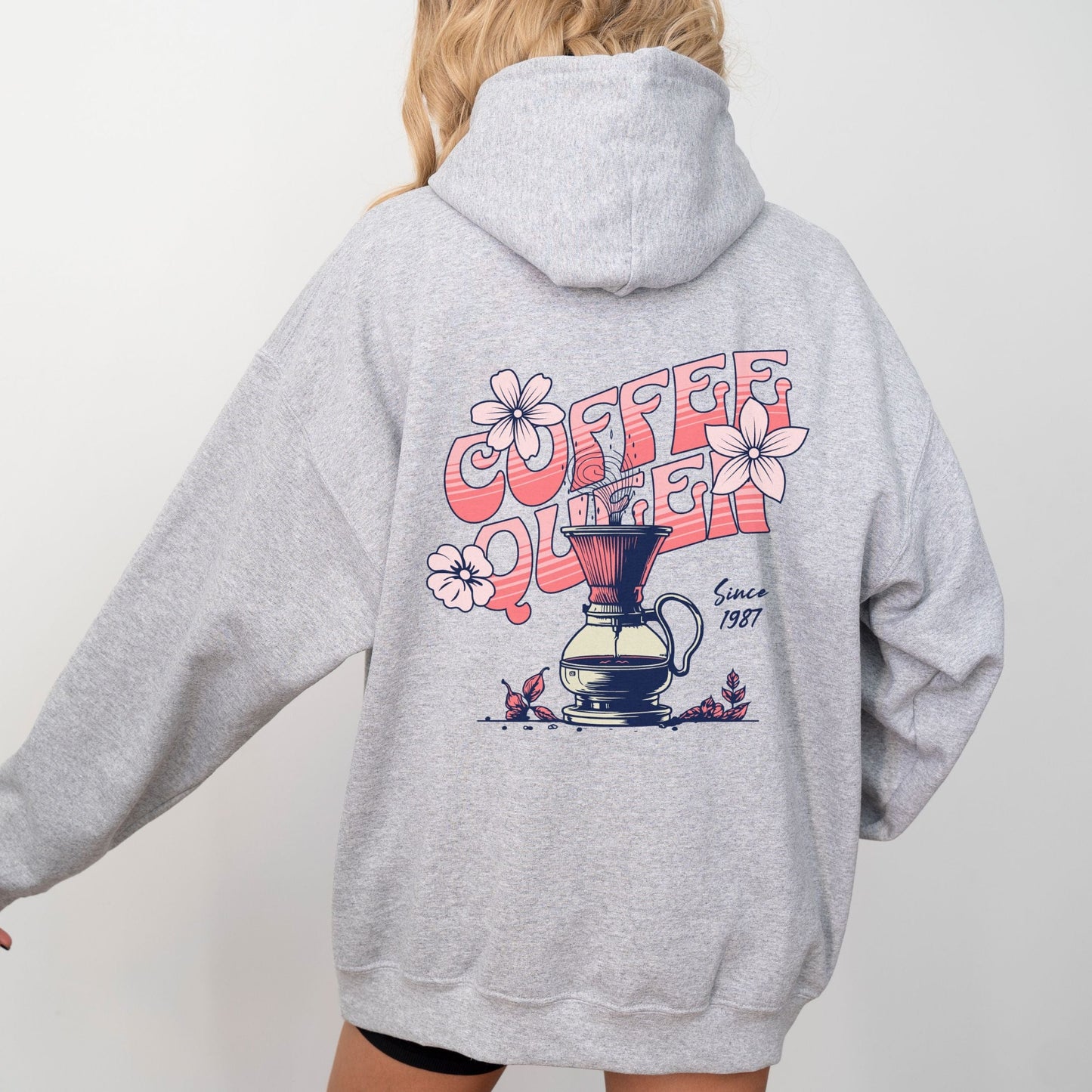 Retro-style “Coffee Queen” text with floral accents and a coffee pour-over illustration on back of a hoodie