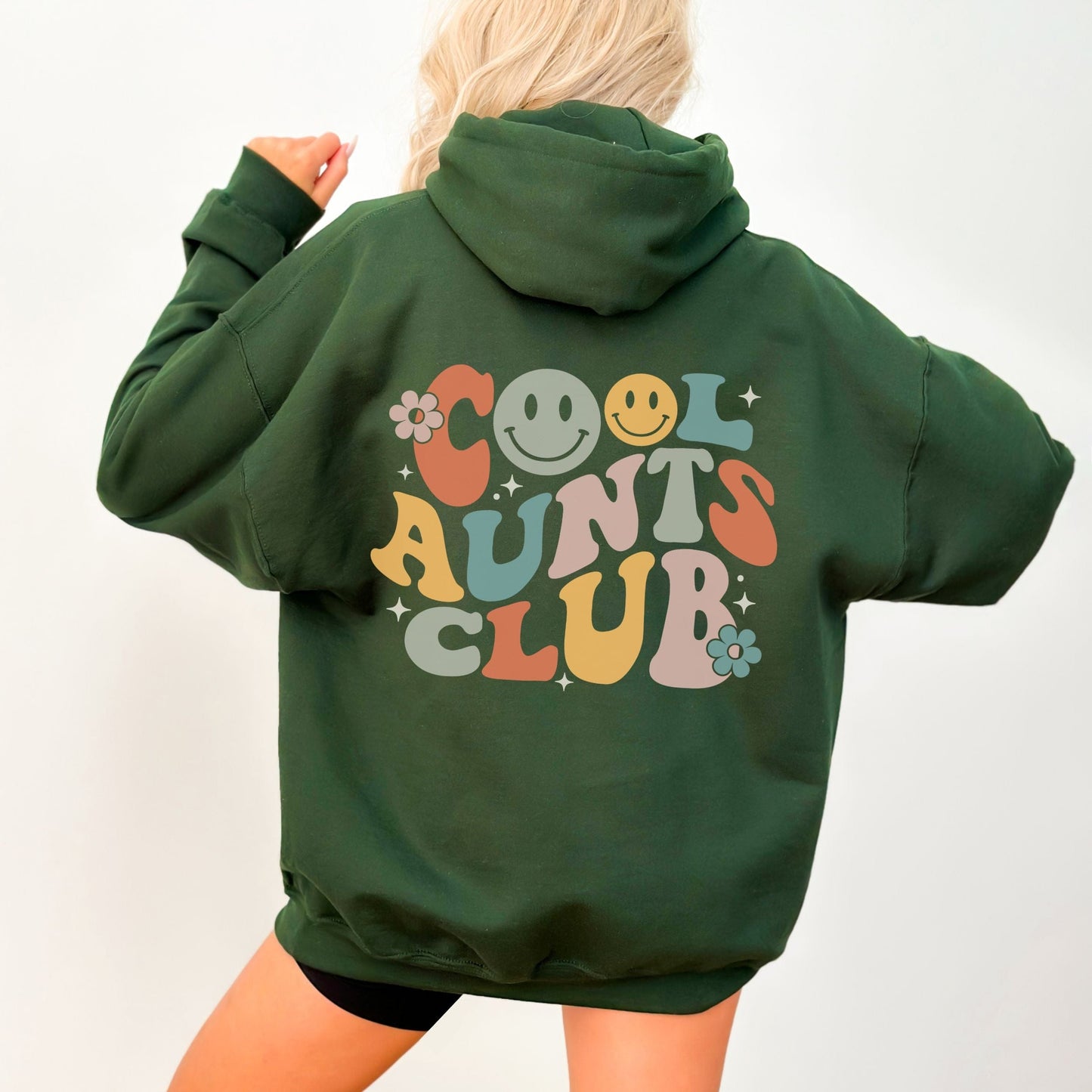Retro multicolor “Cool Aunts Club” graphic with smiley faces and flowers on the back of a hoodie