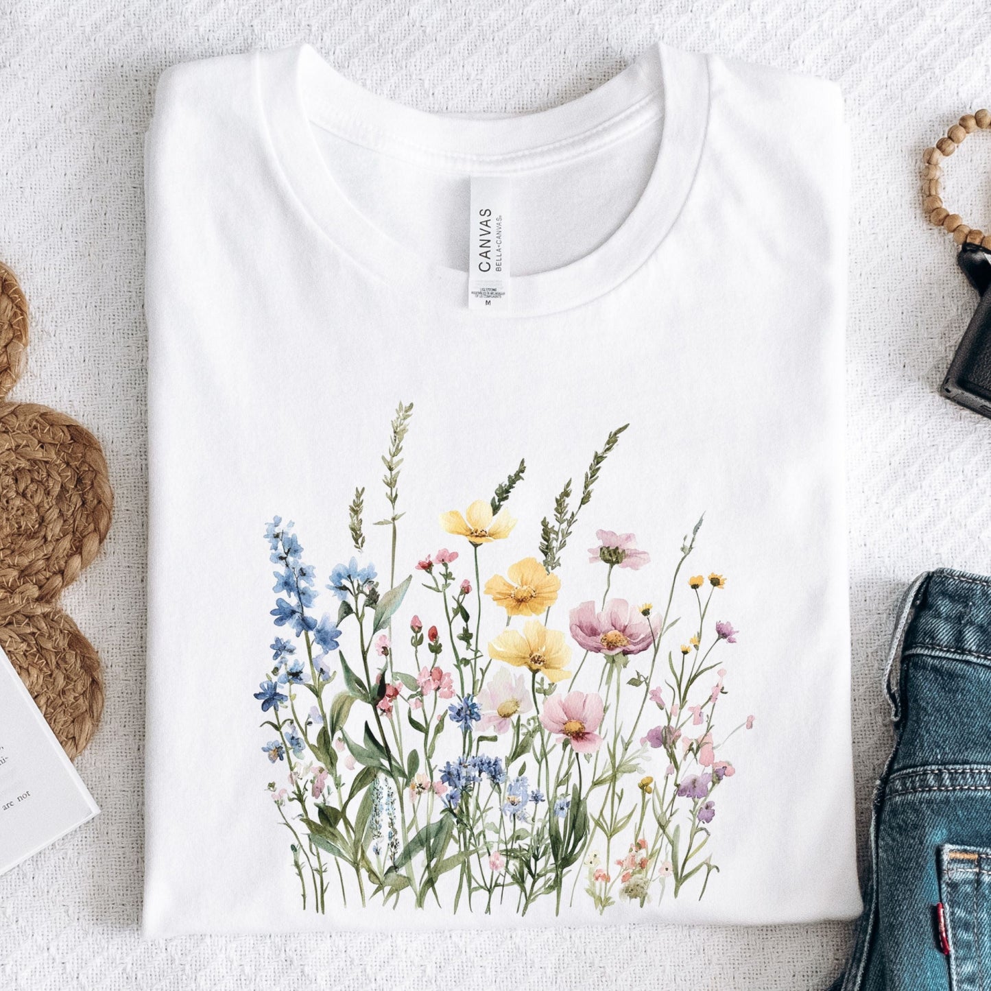 Watercolor wildflower illustration on a cottagecore-style t-shirt in white