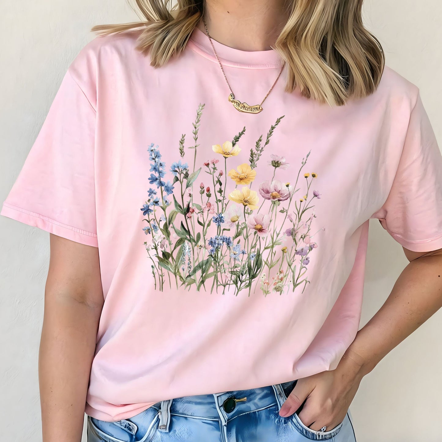 Watercolor wildflower illustration on a cottagecore-style t-shirt in soft pink