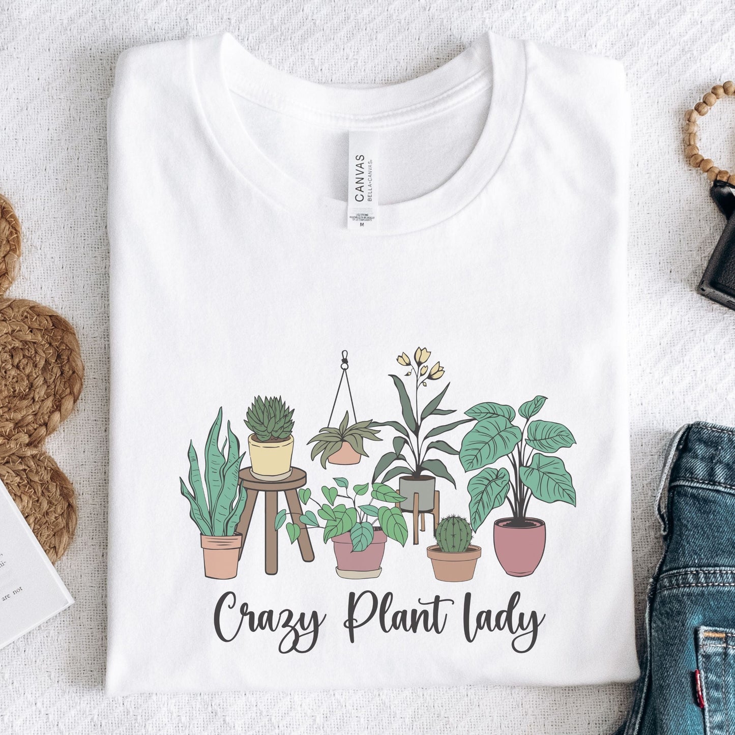 “Crazy Plant Lady” t-shirt with hand-drawn houseplants in terra cotta pots, stands, and hanging planters. Earthy, whimsical design.
