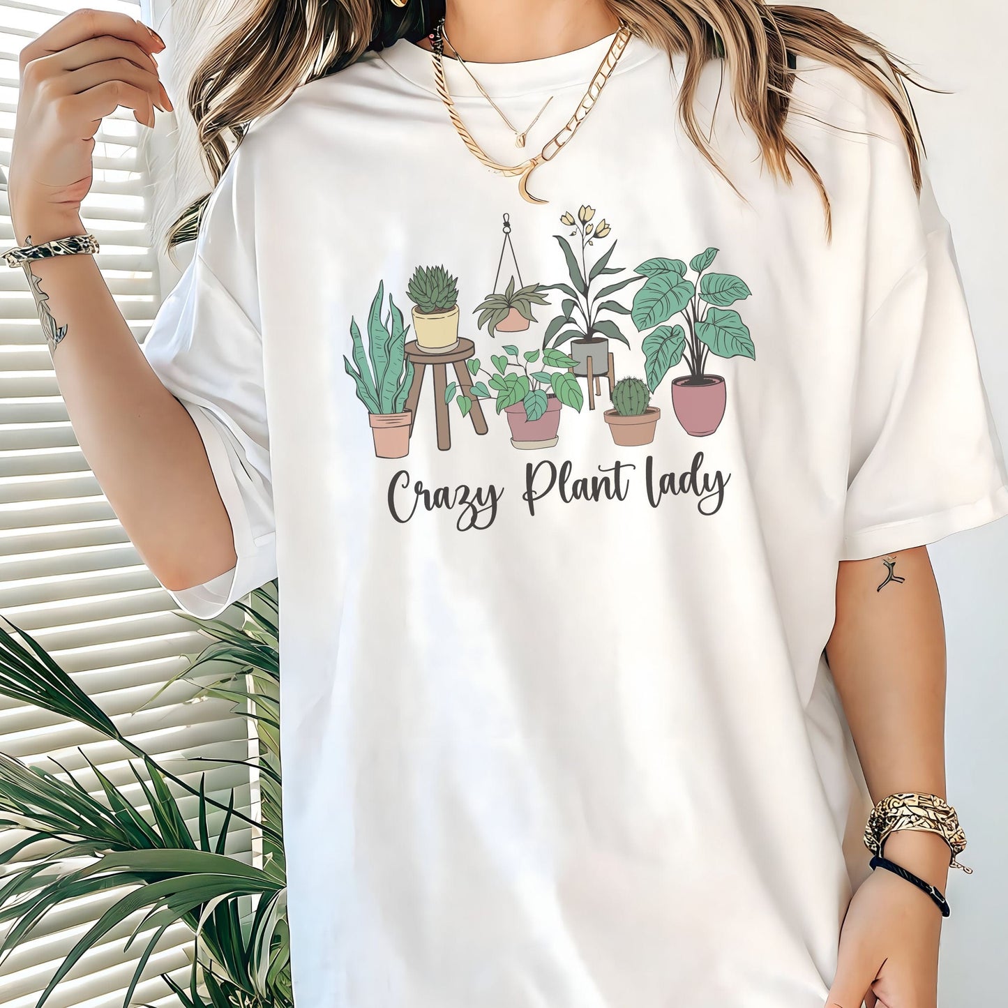 “Crazy Plant Lady” t-shirt with hand-drawn houseplants in terra cotta pots, stands, and hanging planters. Earthy, whimsical design.