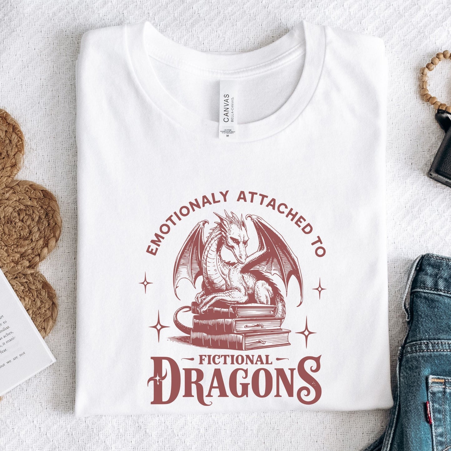 Folded t-shirt with vintage-style dragon illustration in white