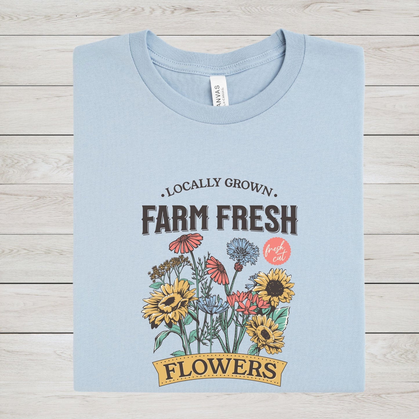 “Farm Fresh Flowers” t-shirt with vintage hand-drawn wildflowers, sunflowers, and colorful bouquet design. Includes “Locally Grown” and “Fresh Cut” text.