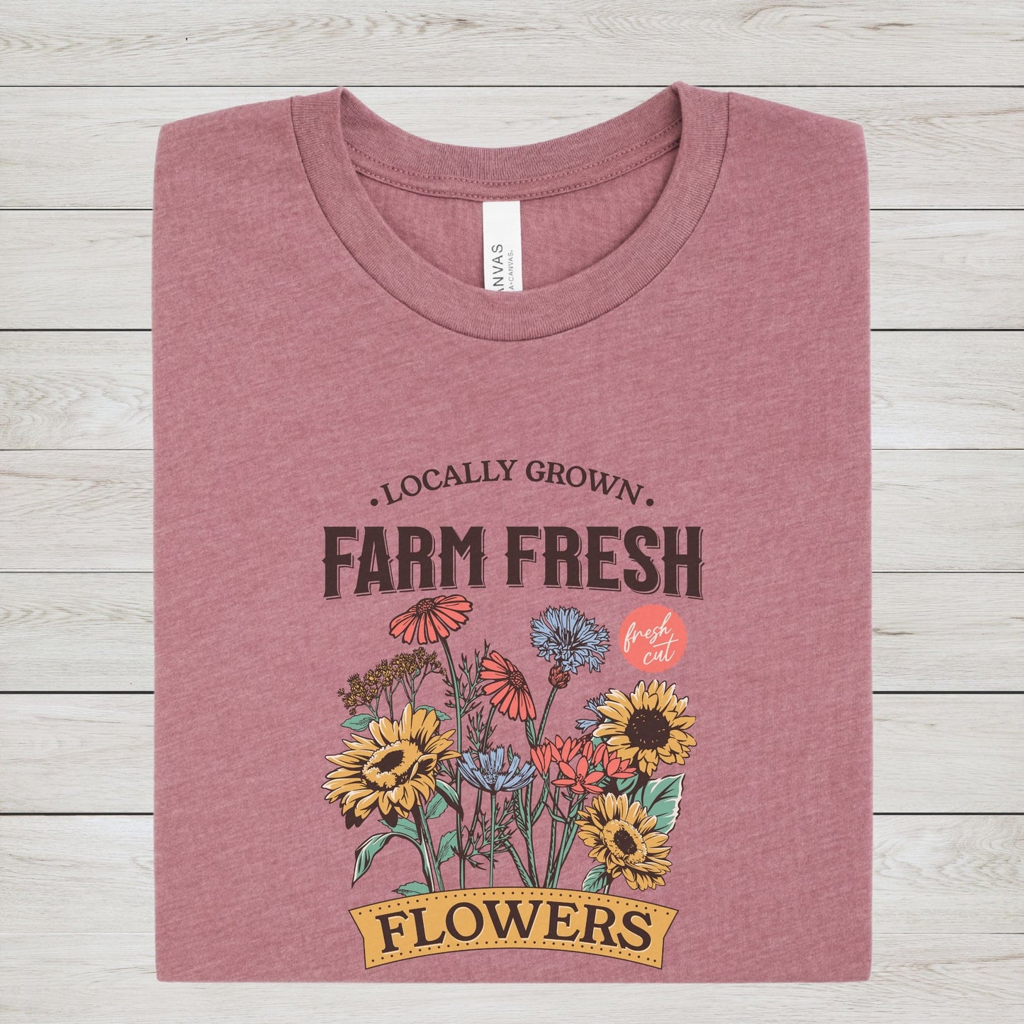 “Farm Fresh Flowers” t-shirt with vintage hand-drawn wildflowers, sunflowers, and colorful bouquet design. Includes “Locally Grown” and “Fresh Cut” text.