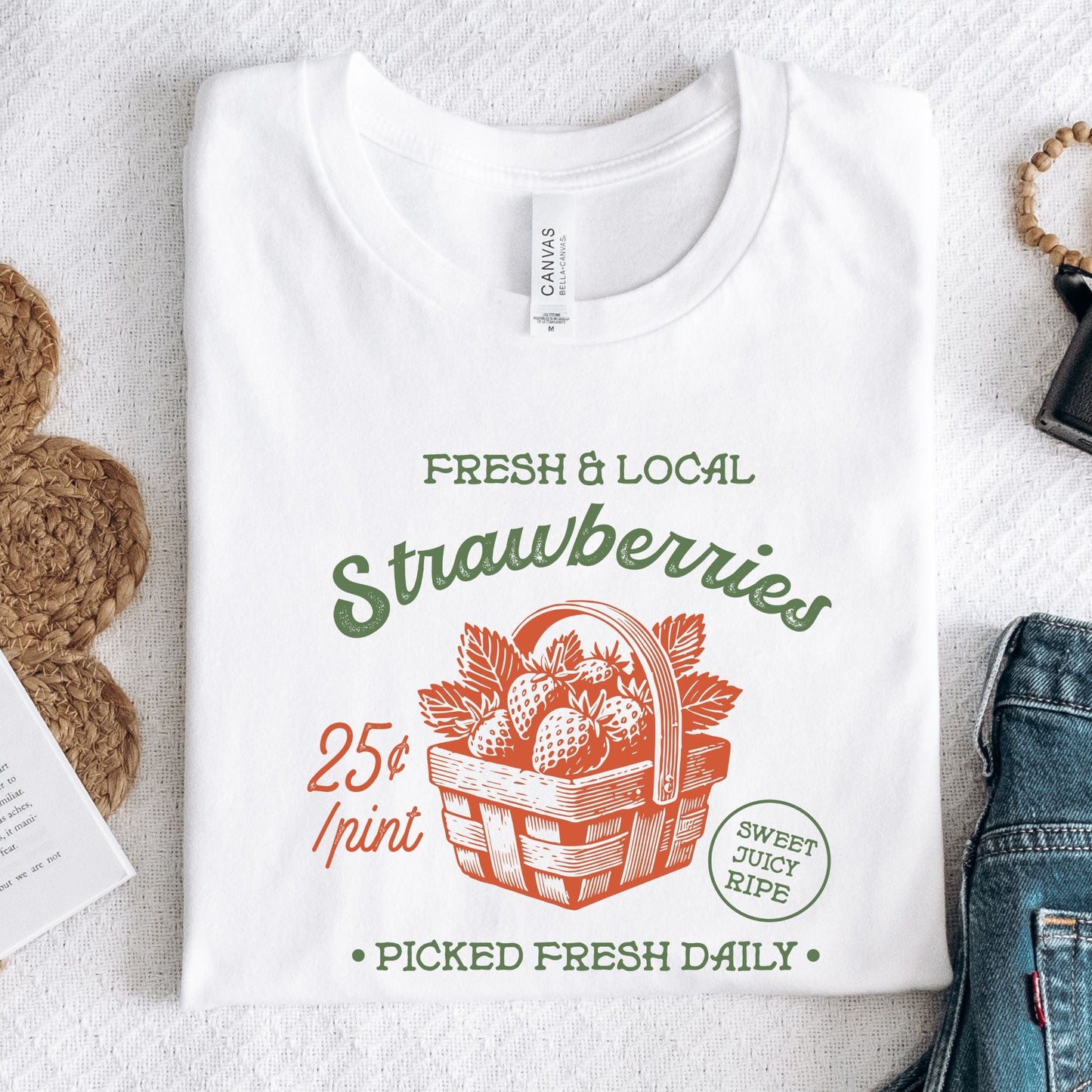 Folded tee with vintage strawberry print and retro produce design in white