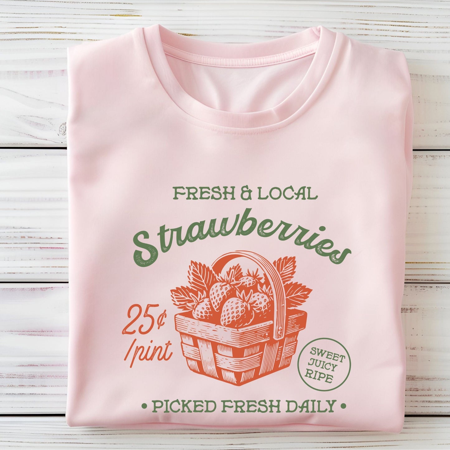 Folded tee with vintage strawberry print and retro produce design in soft pink