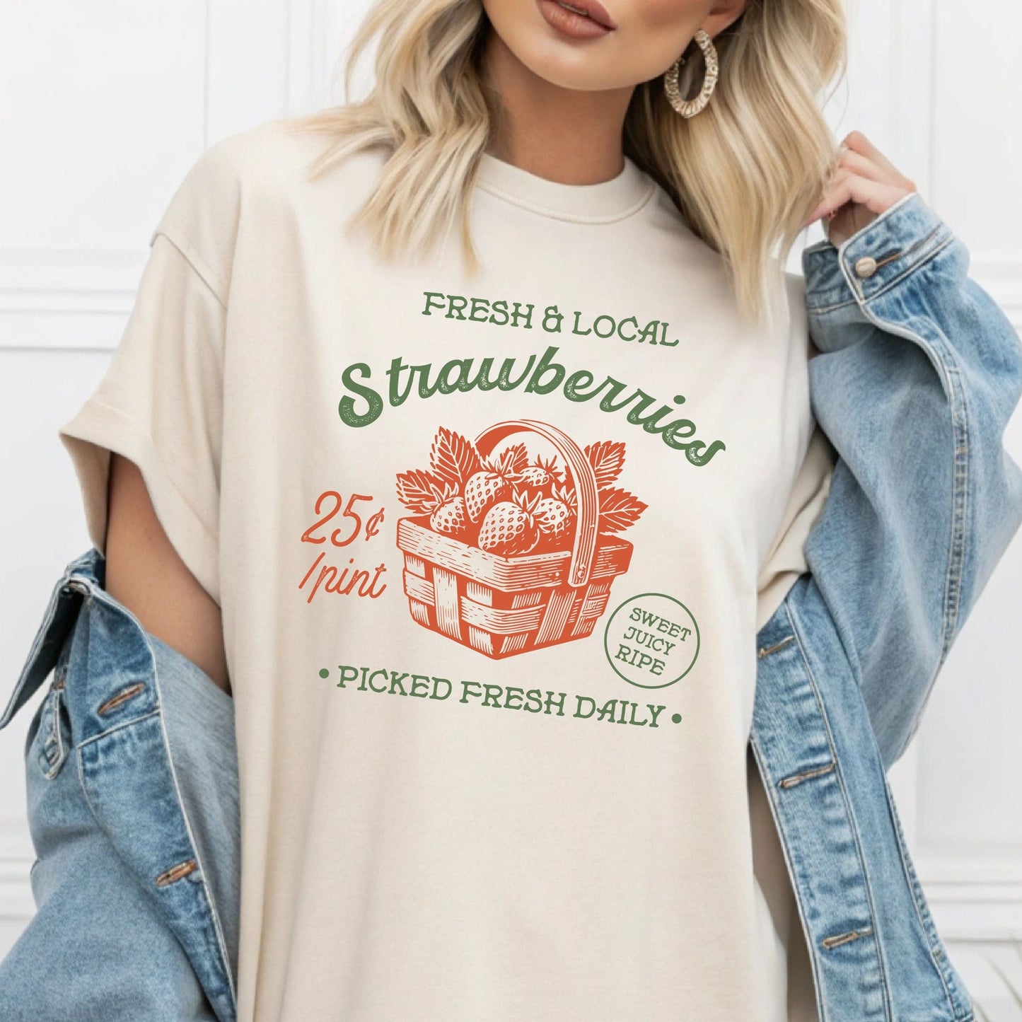Person wearing "Fresh & Local Strawberries" t-shirt with red basket design