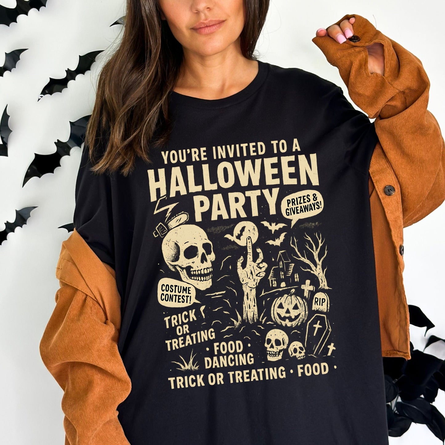 Retro Halloween party skeleton graphic tee with spooky cartoon skulls, tombstones, and vintage lettering