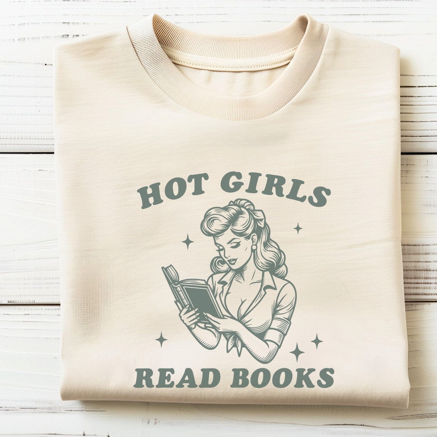 “Hot Girls Read Books” t-shirt with retro-style pin-up woman reading a book in vintage line art, surrounded by stars.