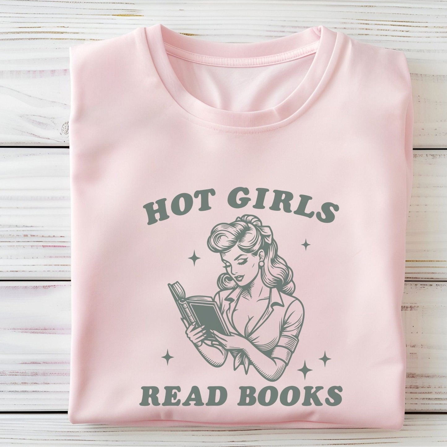 “Hot Girls Read Books” t-shirt with retro-style pin-up woman reading a book in vintage line art, surrounded by stars.