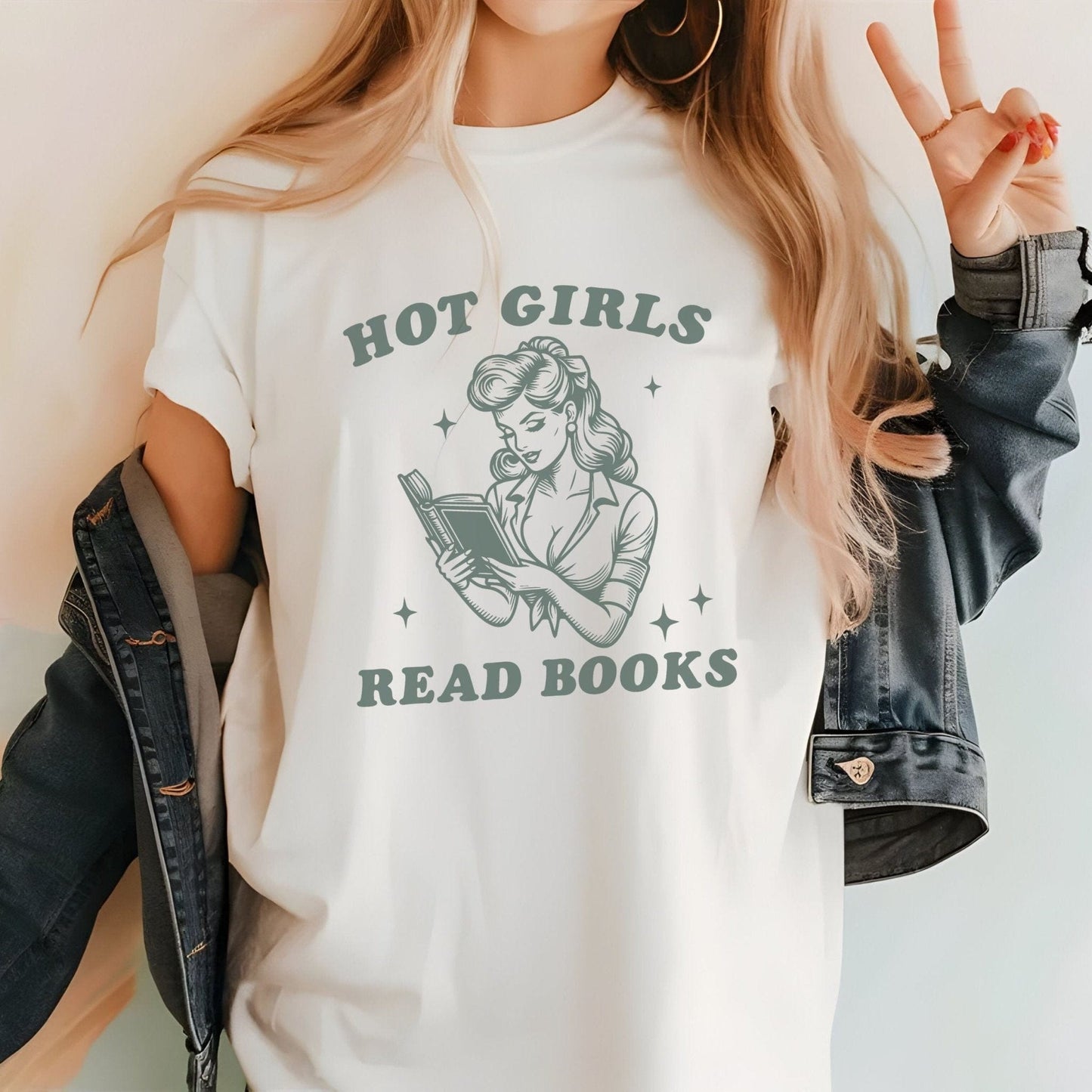 “Hot Girls Read Books” t-shirt with retro-style pin-up woman reading a book in vintage line art, surrounded by stars.