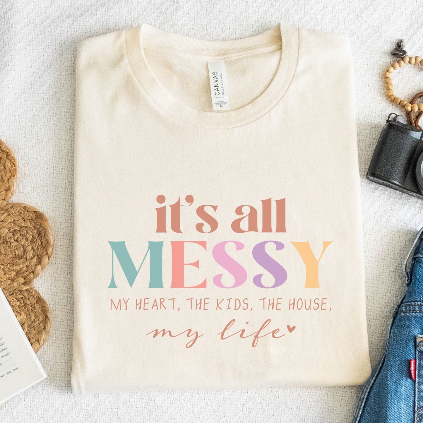 Colorful graphic design that says "It’s All Messy – My Heart, The Kids, The House, My Life," printed on a comfy t-shirt.