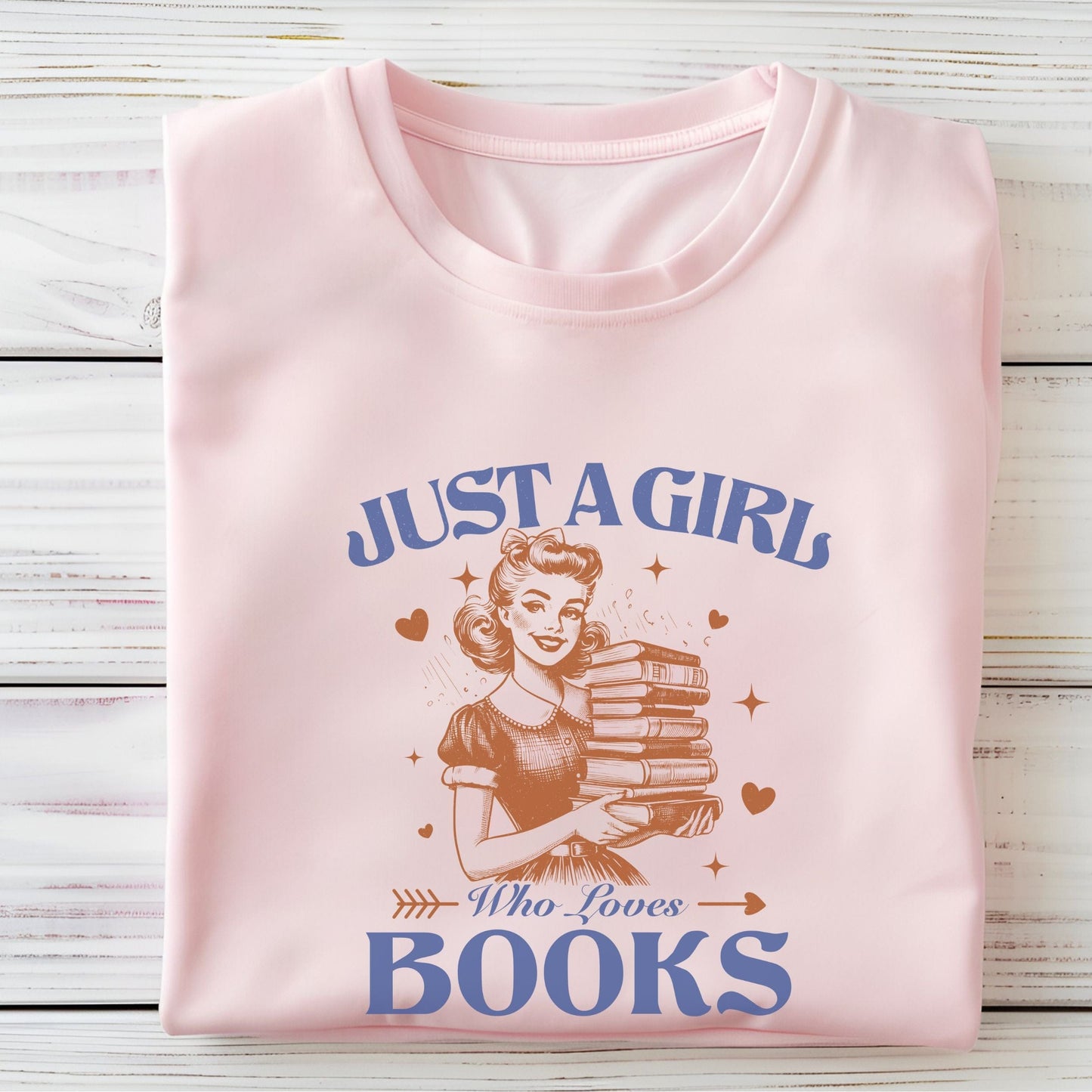 Vintage-style graphic tee that says "Just a Girl Who Loves Books" with a retro girl holding a stack of books and heart accents.