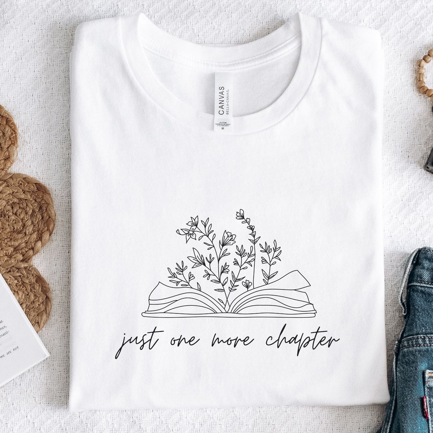 “Just One More Chapter” t-shirt with floral book line art — minimal design perfect for book lovers and cozy, casual style.