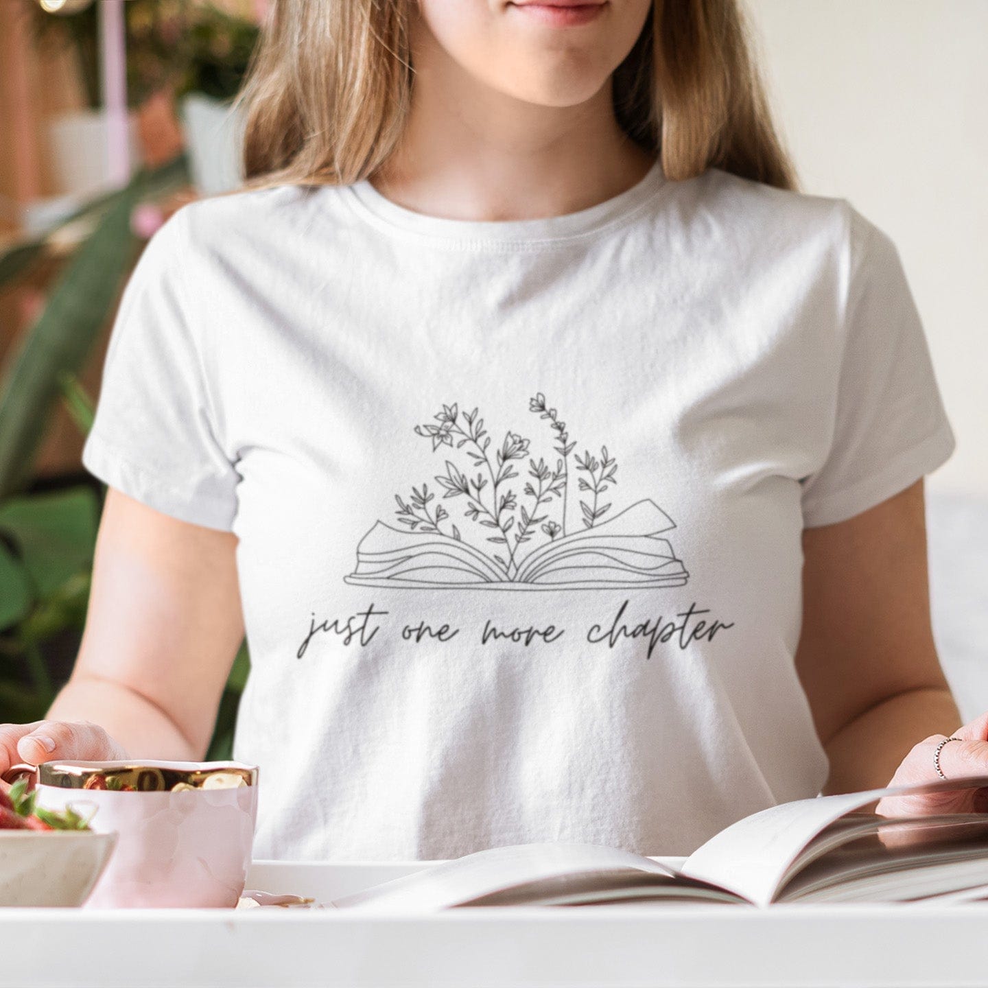 “Just One More Chapter” t-shirt with floral book line art — minimal design perfect for book lovers and cozy, casual style.