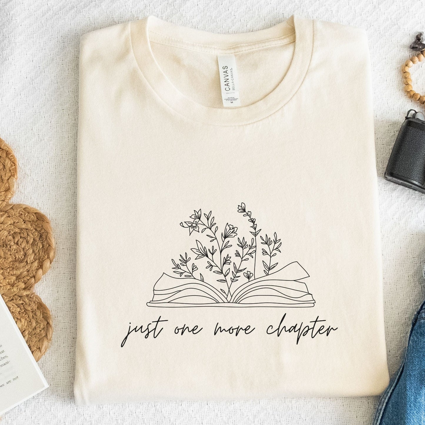 “Just One More Chapter” t-shirt with floral book line art — minimal design perfect for book lovers and cozy, casual style.