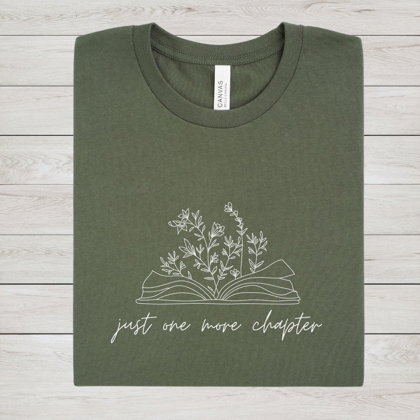 “Just One More Chapter” t-shirt with floral book line art — minimal design perfect for book lovers and cozy, casual style.