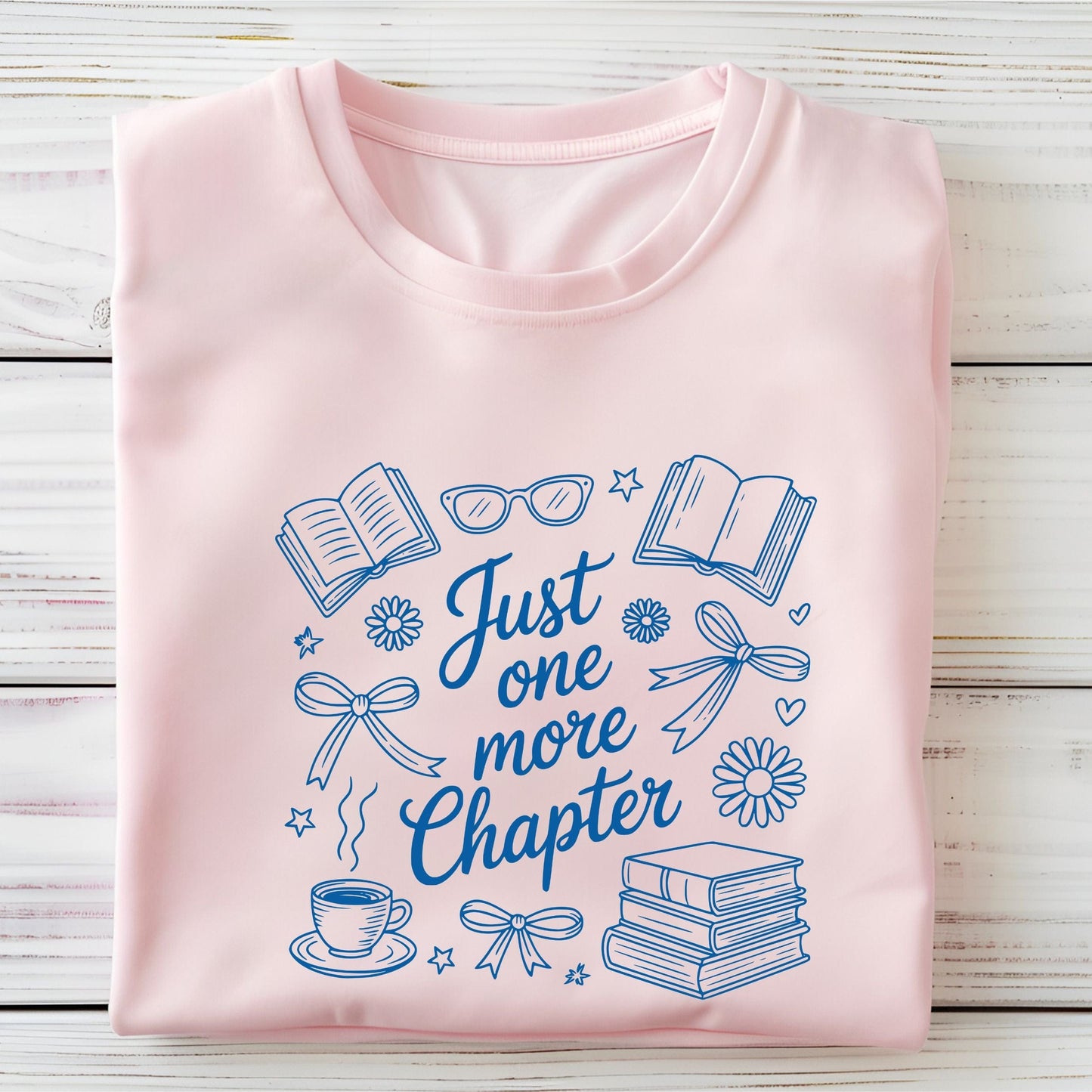 Just One More Chapter t-shirt in a cozy book lover aesthetic with bows, books, and daisies on front design