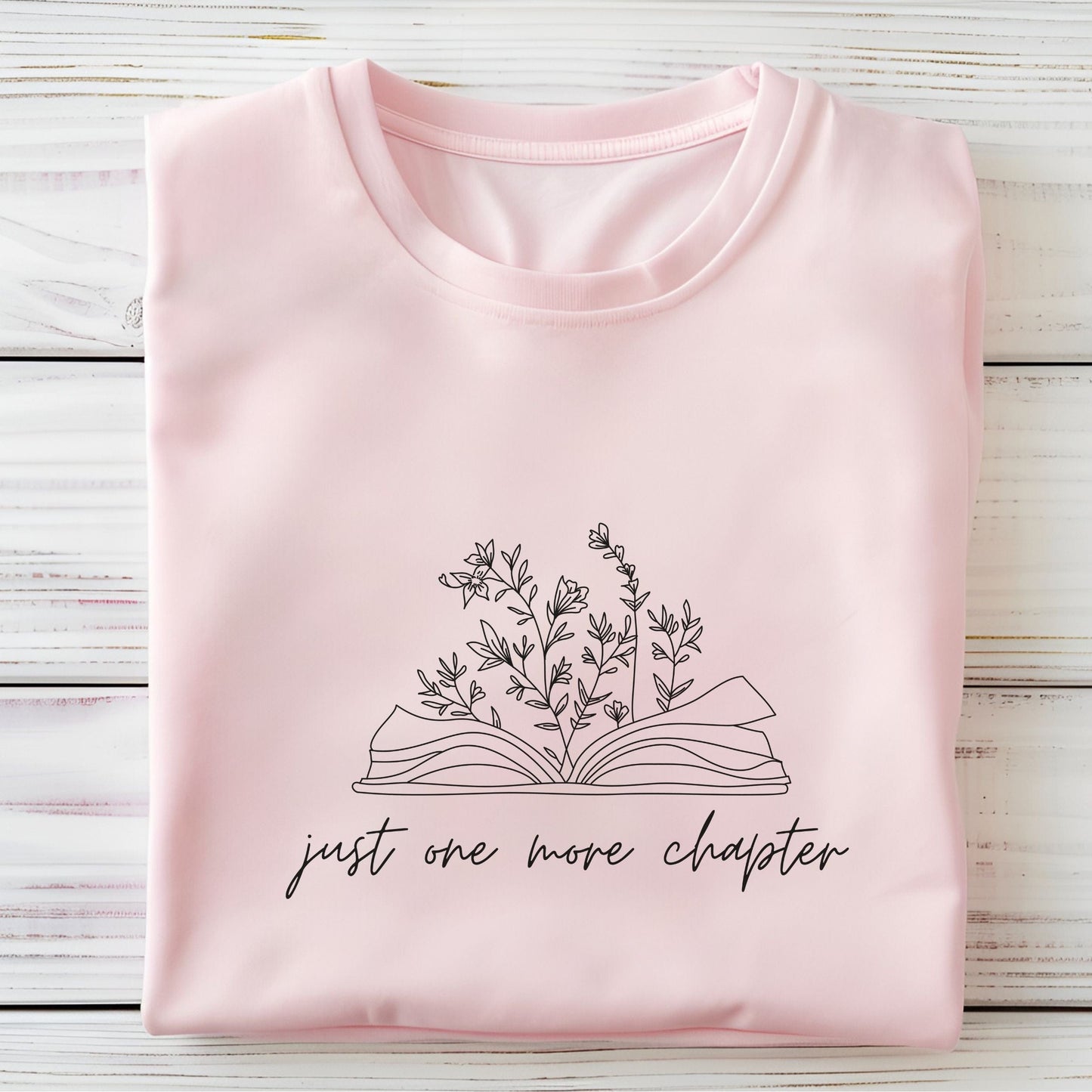 “Just One More Chapter” t-shirt with floral book line art — minimal design perfect for book lovers and cozy, casual style.