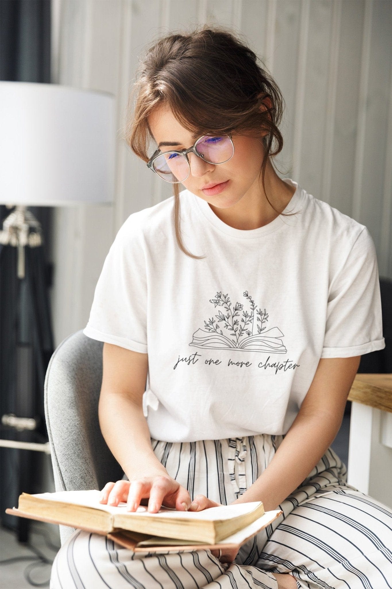 “Just One More Chapter” t-shirt with floral book line art — minimal design perfect for book lovers and cozy, casual style.