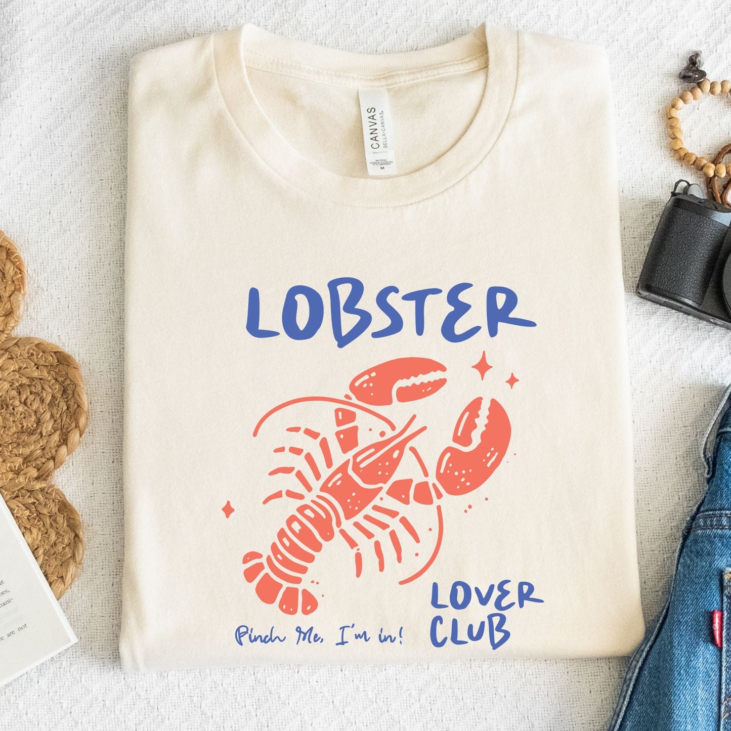 Colorful cartoon lobster with the phrase "Lobster Lover Club – Pinch Me, I'm In!" on a fun summer t-shirt for seafood and beach lovers.