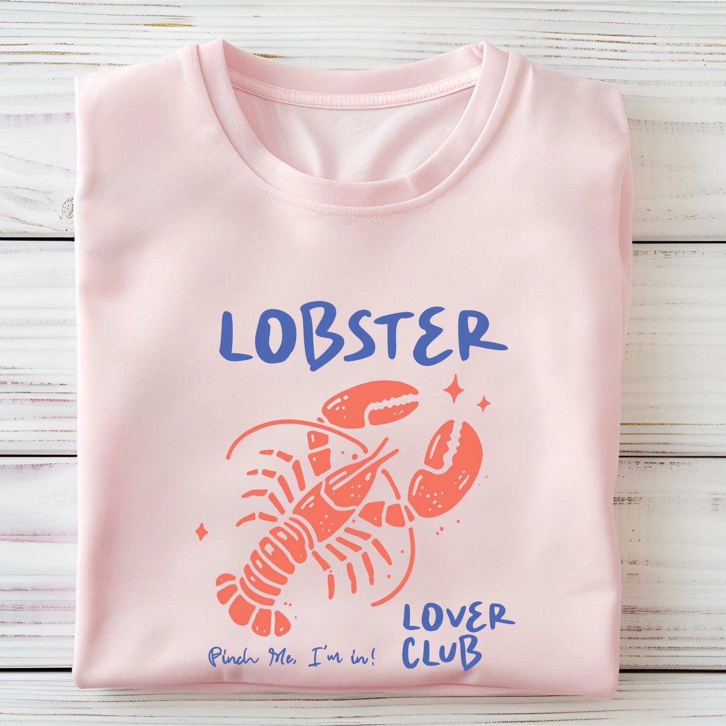 Colorful cartoon lobster with the phrase "Lobster Lover Club – Pinch Me, I'm In!" on a fun summer t-shirt for seafood and beach lovers.
