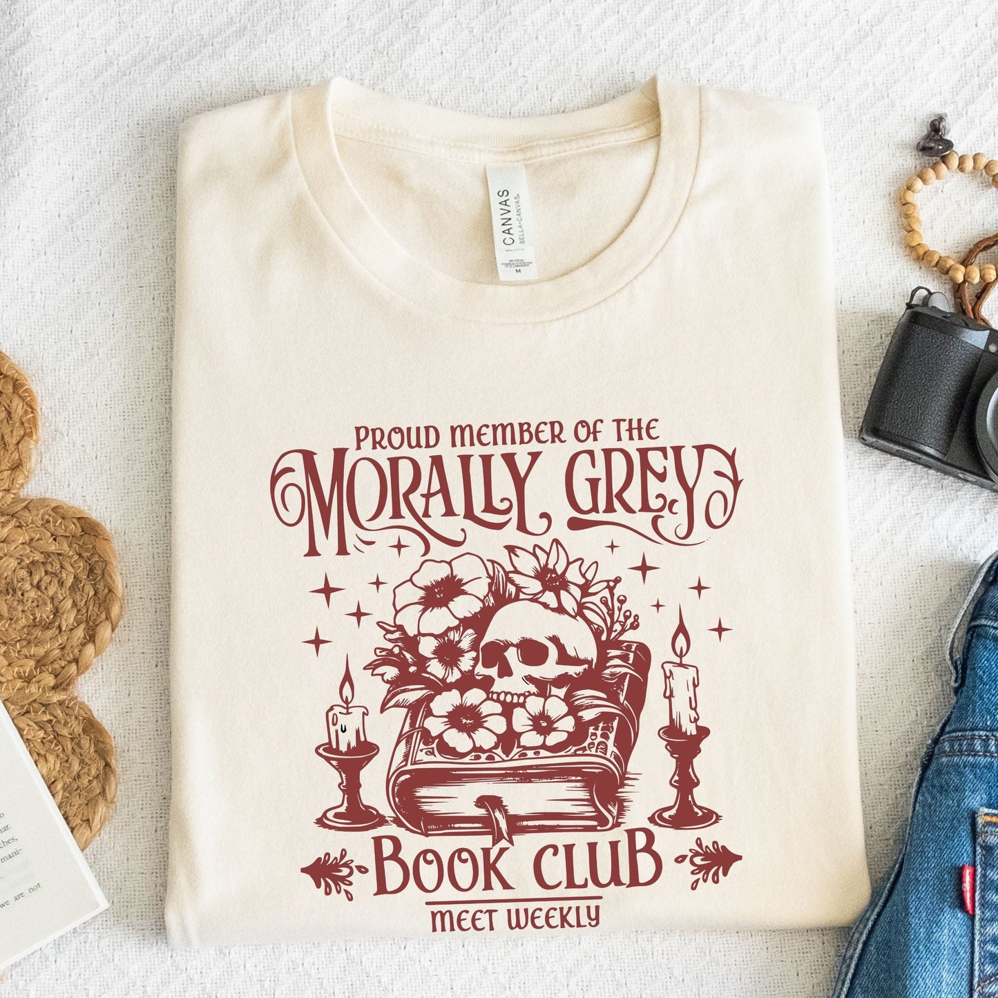 Folded t-shirt with dark fantasy-style text design in natural