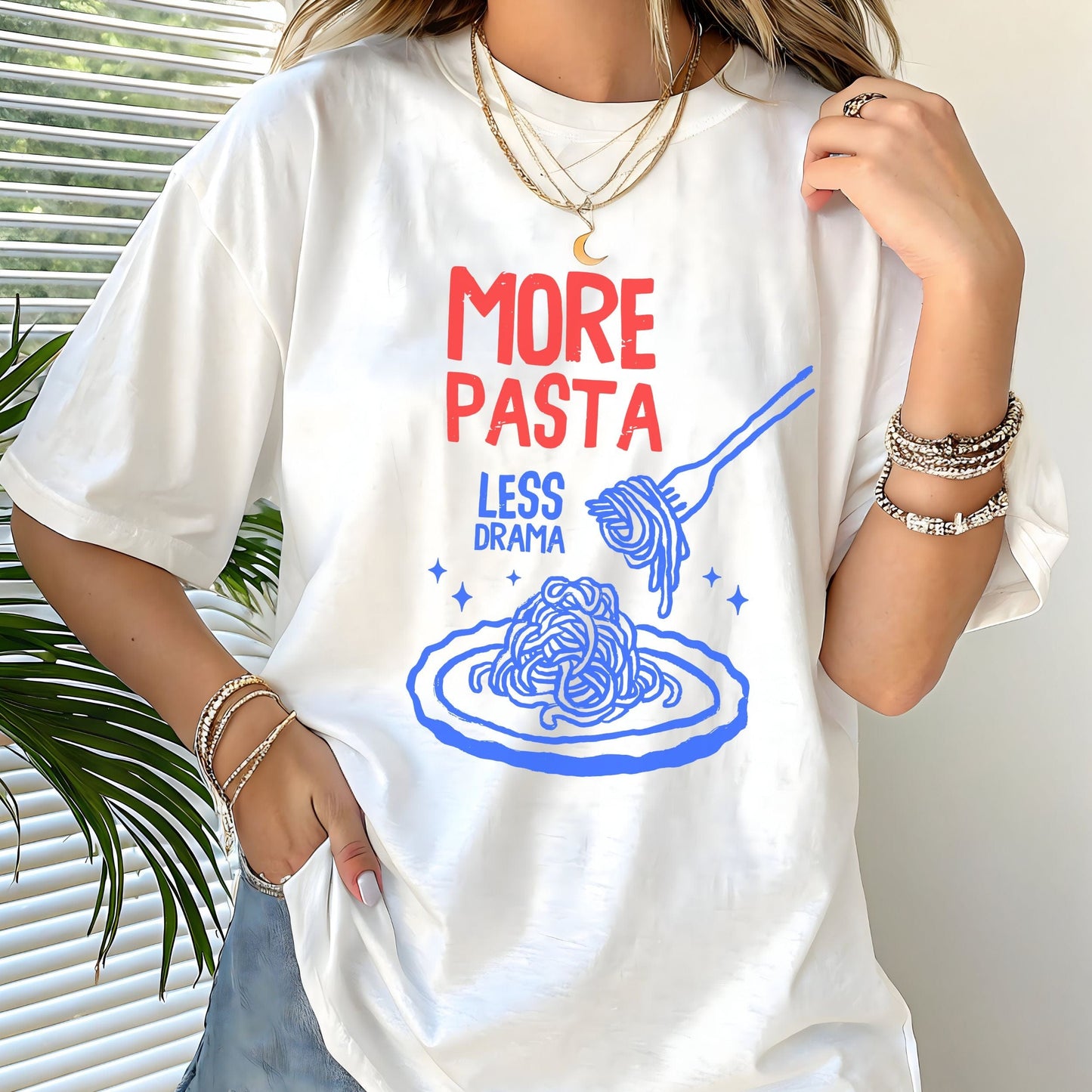T-shirt with a plate of spaghetti and fork illustration and “More Pasta, Less Drama” text in white