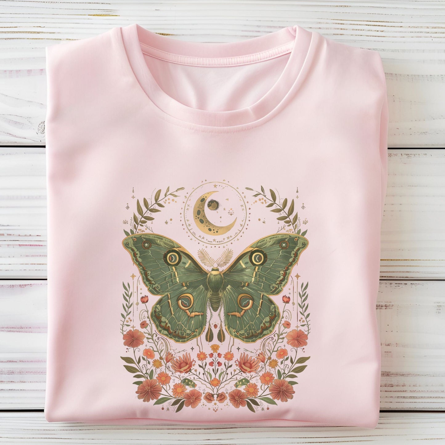T-shirt design featuring a green luna moth with moon and stars above, surrounded by whimsical flowers and botanical elements in a cottagecore style
