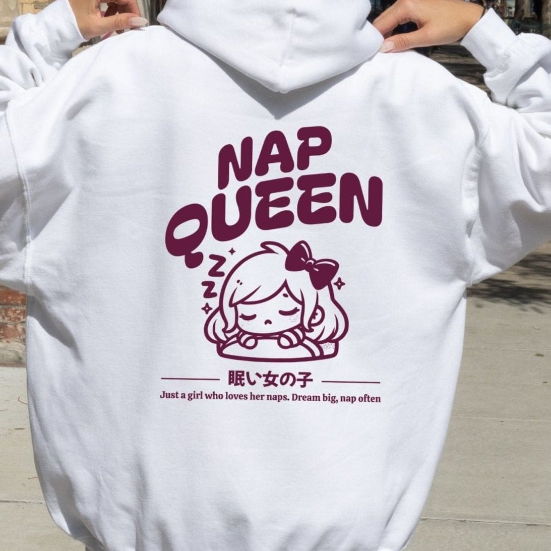 Hoodie with back print featuring "Nap Queen" text, a sleepy girl with bow, Zzz symbols, and kawaii-inspired style — perfect for cozy nap lovers.