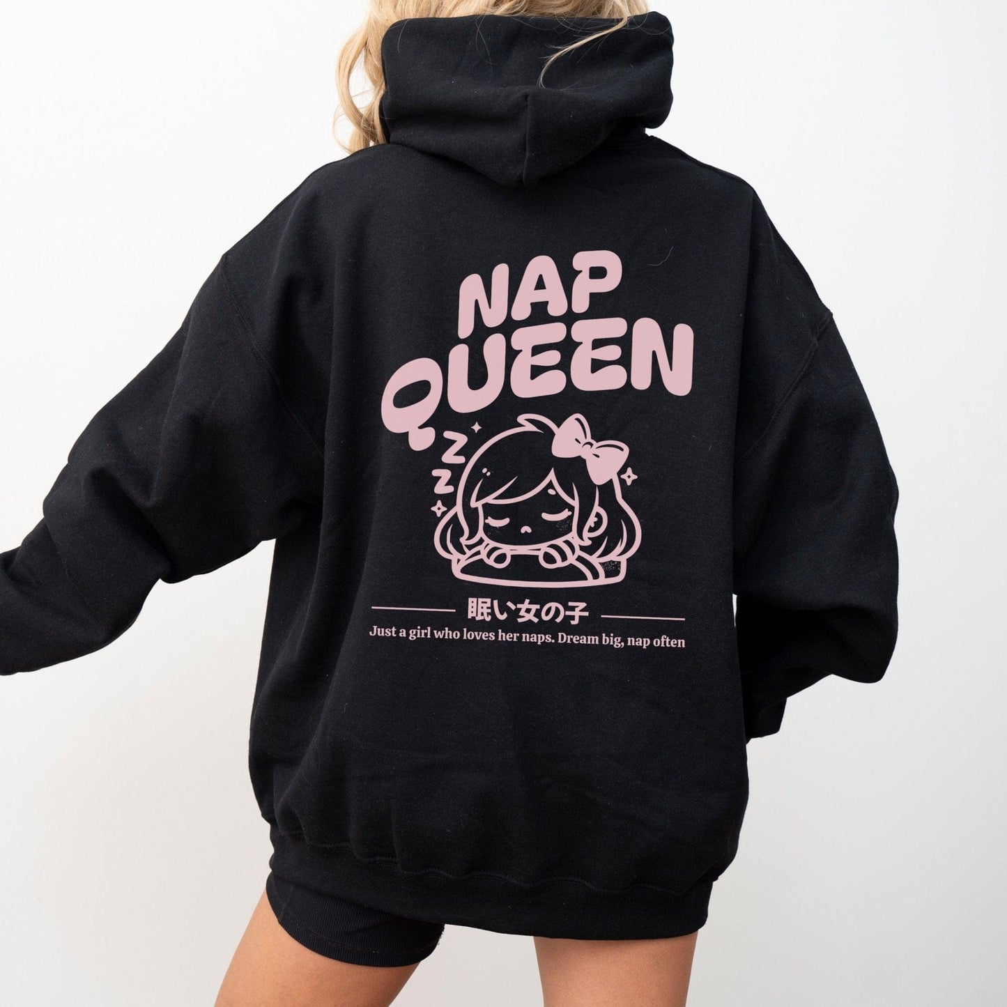 Hoodie with back print featuring "Nap Queen" text, a sleepy girl with bow, Zzz symbols, and kawaii-inspired style — perfect for cozy nap lovers.