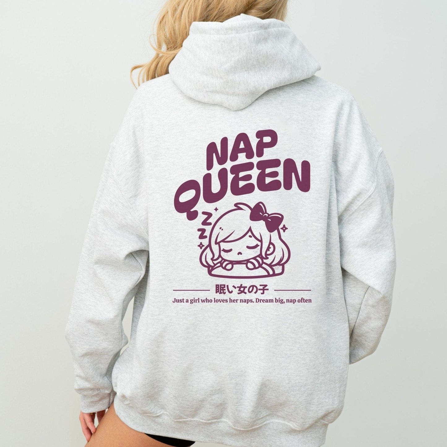 Hoodie with back print featuring "Nap Queen" text, a sleepy girl with bow, Zzz symbols, and kawaii-inspired style — perfect for cozy nap lovers.