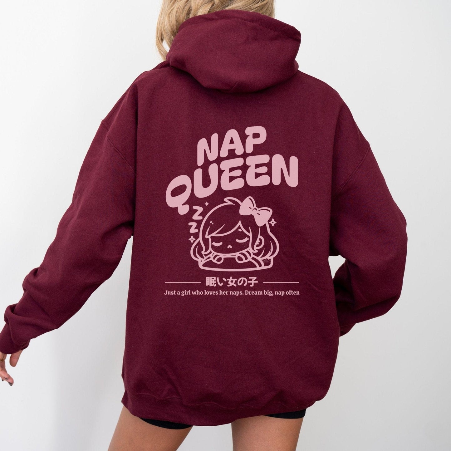 Hoodie with back print featuring "Nap Queen" text, a sleepy girl with bow, Zzz symbols, and kawaii-inspired style — perfect for cozy nap lovers.