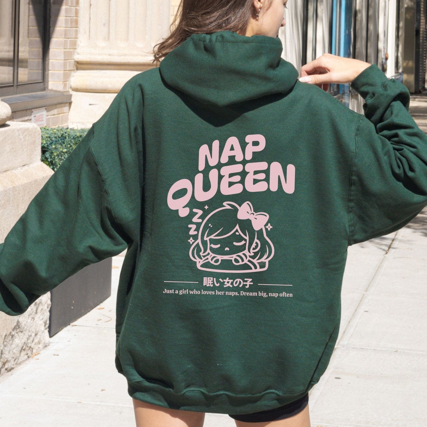 Hoodie with back print featuring "Nap Queen" text, a sleepy girl with bow, Zzz symbols, and kawaii-inspired style — perfect for cozy nap lovers.