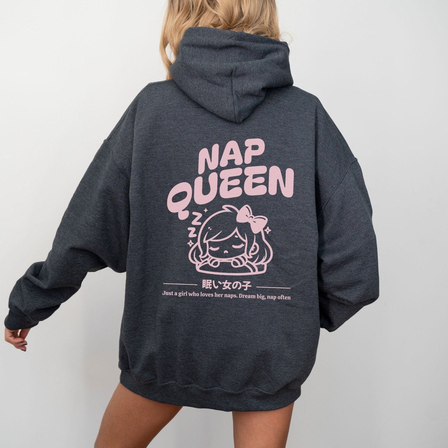 Hoodie with back print featuring "Nap Queen" text, a sleepy girl with bow, Zzz symbols, and kawaii-inspired style — perfect for cozy nap lovers.