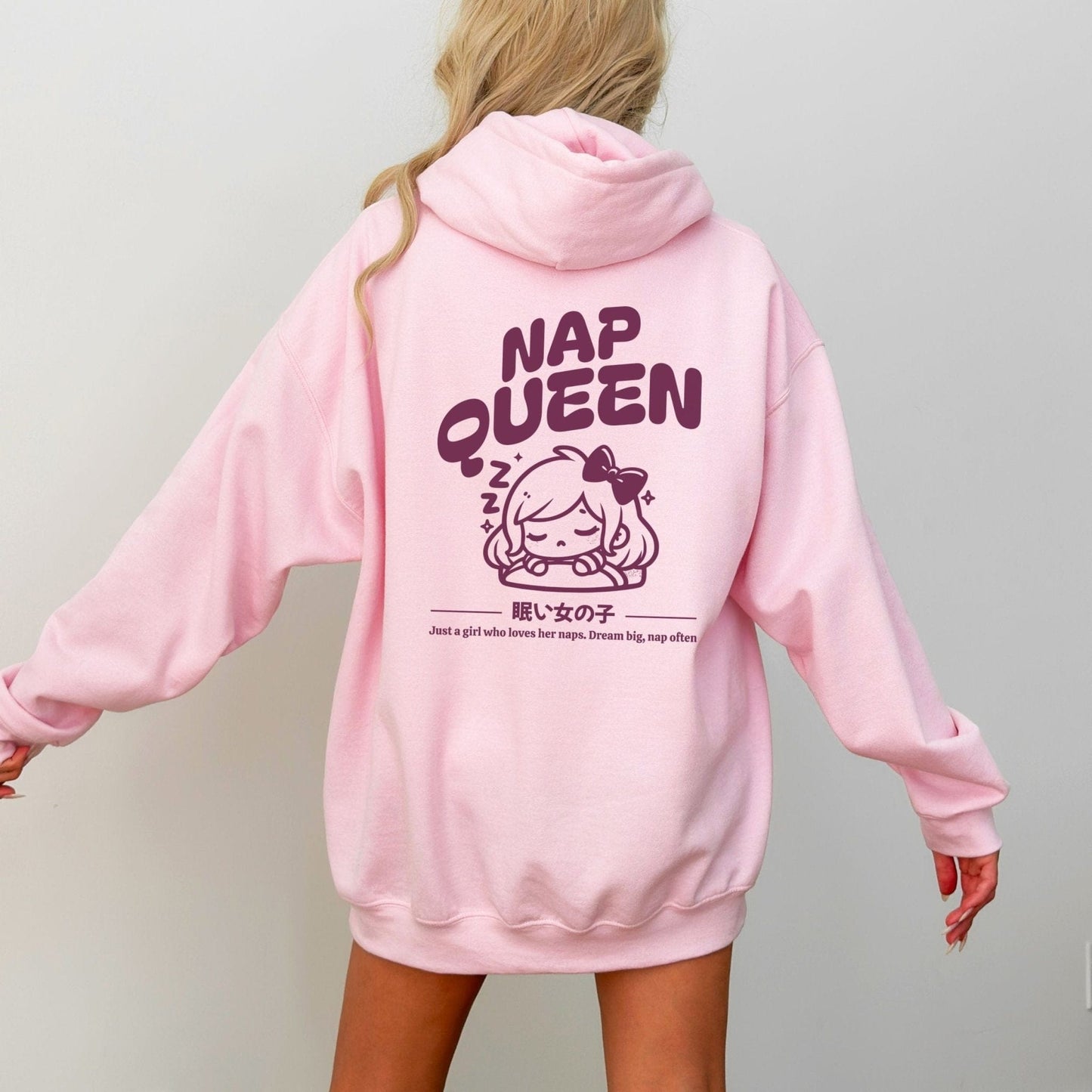 Hoodie with back print featuring "Nap Queen" text, a sleepy girl with bow, Zzz symbols, and kawaii-inspired style — perfect for cozy nap lovers.