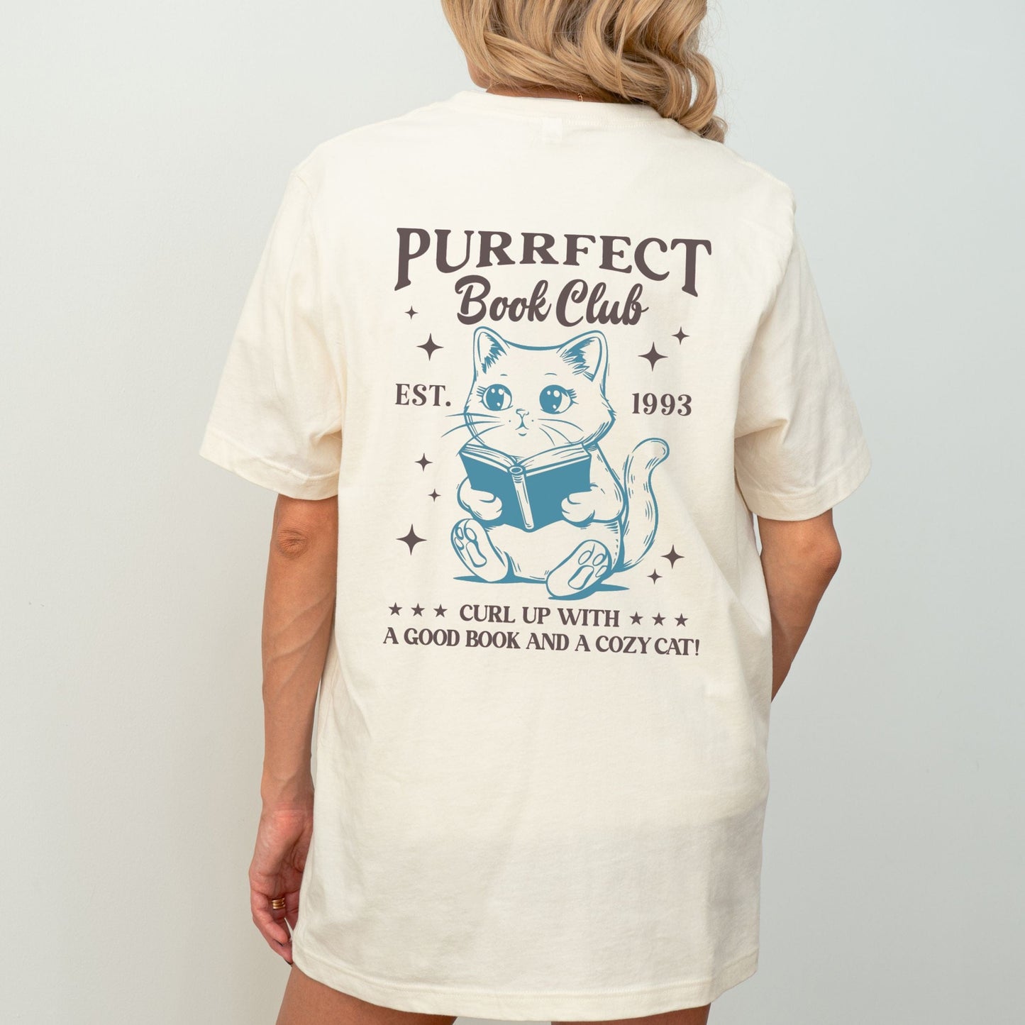 Illustrated cat reading a book with “Purrfect Book Club” text in natural