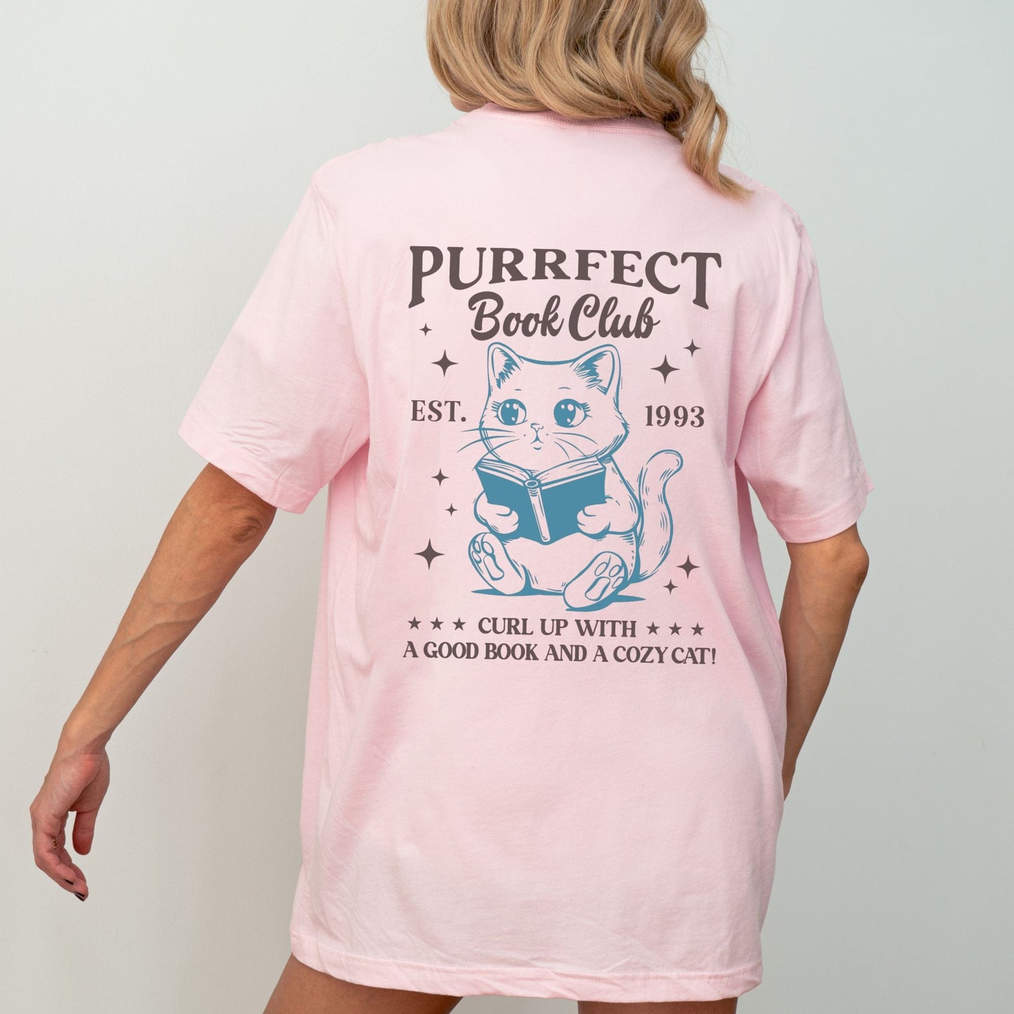 Illustrated cat reading a book with “Purrfect Book Club” text in soft pink