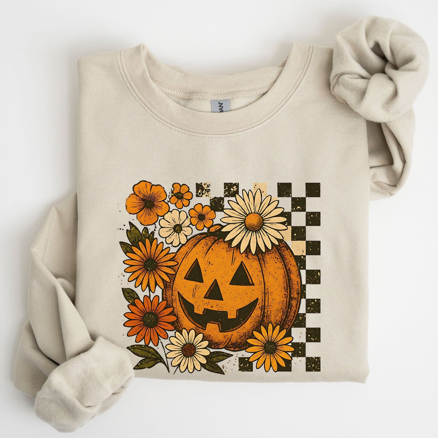 Beige sweatshirt with a pumpkin and floral design on a white background