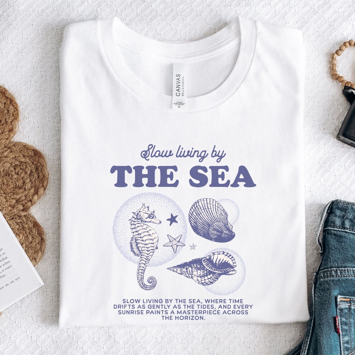 Vintage seahorse and shell graphic with "Slow Living by the Sea" text on t-shirt